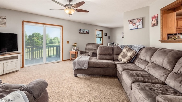 living room with light colored carpet and ceiling fan