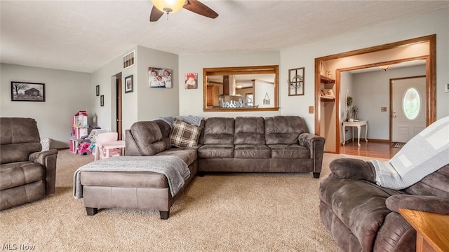 carpeted living room featuring ceiling fan