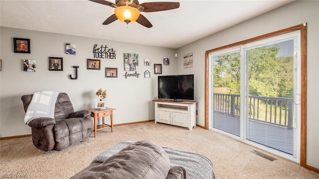 living room featuring ceiling fan and light colored carpet