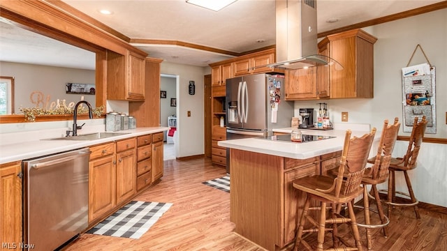 kitchen featuring island range hood, light hardwood / wood-style flooring, appliances with stainless steel finishes, a breakfast bar, and sink