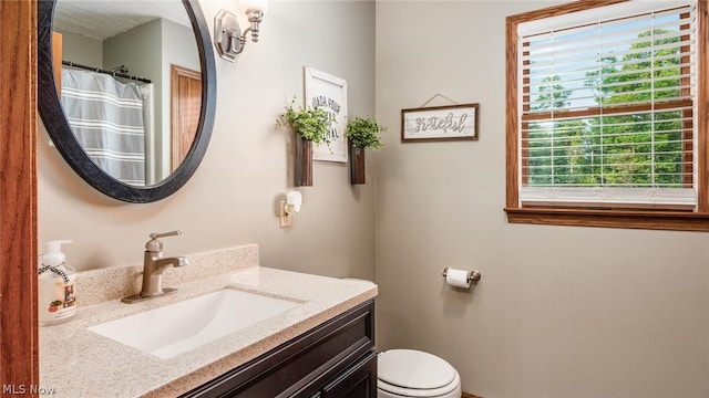 bathroom featuring vanity and toilet