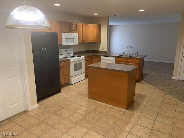 kitchen featuring sink, a center island, kitchen peninsula, light colored carpet, and white appliances