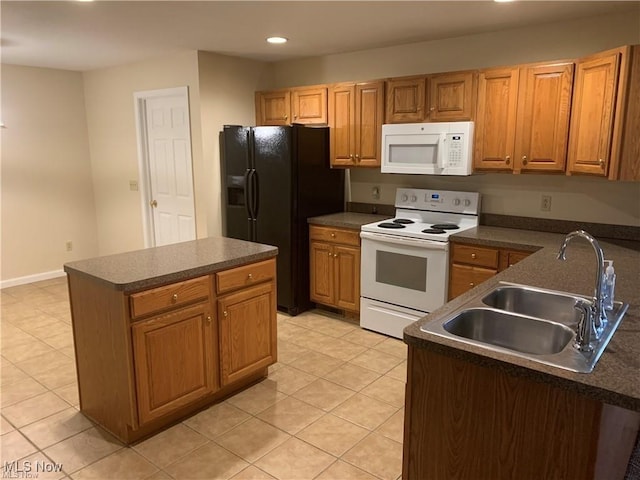 kitchen featuring a center island, white appliances, sink, and light tile patterned floors