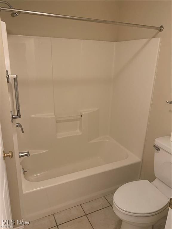 bathroom featuring tile patterned floors, toilet, and shower / bathing tub combination