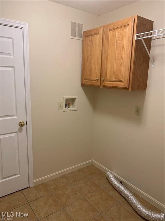 laundry area with tile patterned floors, cabinets, and washer hookup