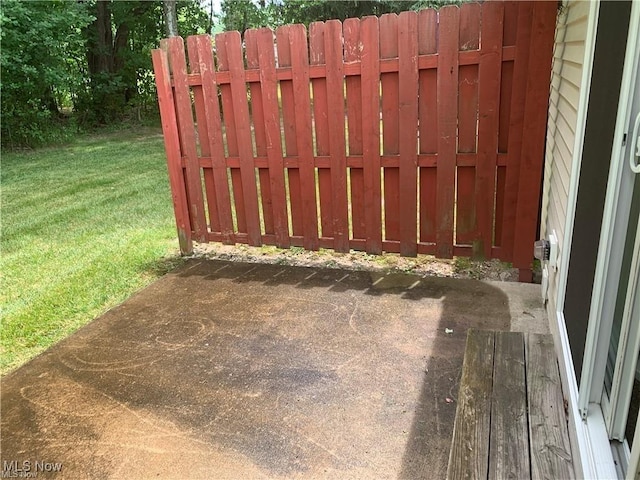 view of gate featuring a yard and a patio