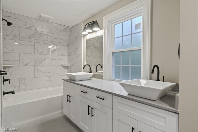 bathroom featuring tile patterned floors, vanity, and tiled shower / bath