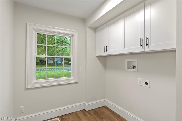 laundry room with hookup for an electric dryer, hookup for a washing machine, cabinets, and hardwood / wood-style flooring