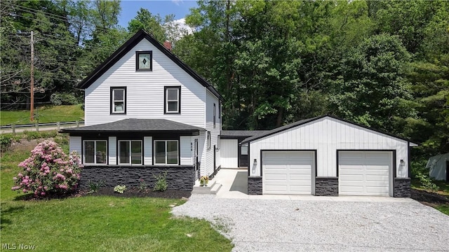 view of front of property with a garage and a front lawn