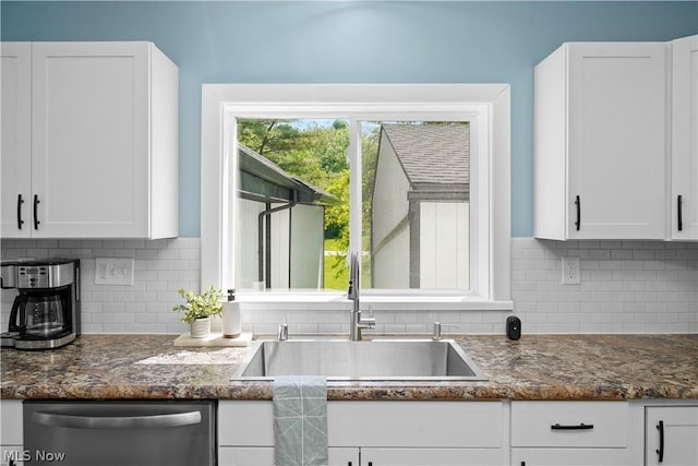 kitchen with dishwasher, decorative backsplash, white cabinetry, and sink