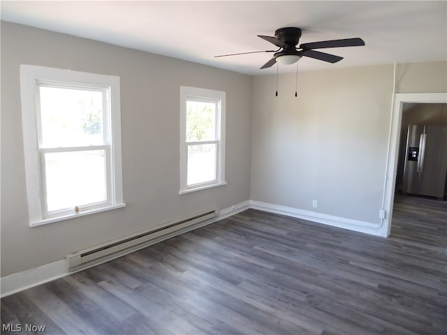 empty room featuring ceiling fan, dark wood-type flooring, and a baseboard radiator