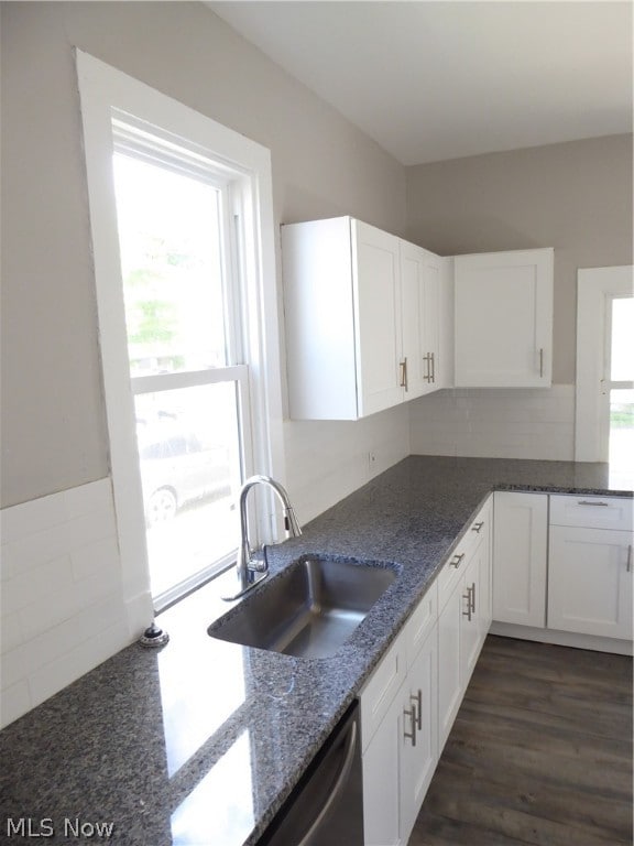 kitchen with white cabinets, dark hardwood / wood-style flooring, sink, and dark stone counters