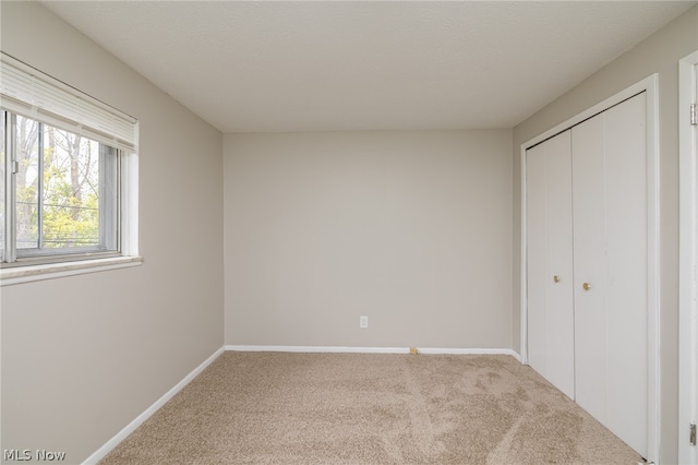 unfurnished bedroom with a closet and carpet floors