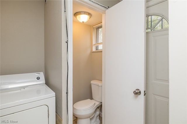 bathroom featuring vanity, toilet, tile floors, and washer / clothes dryer