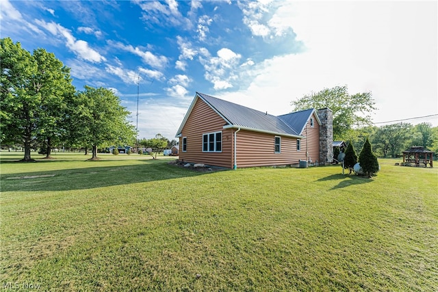 view of side of home featuring a yard