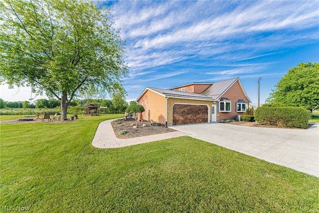 view of side of property with a garage and a yard