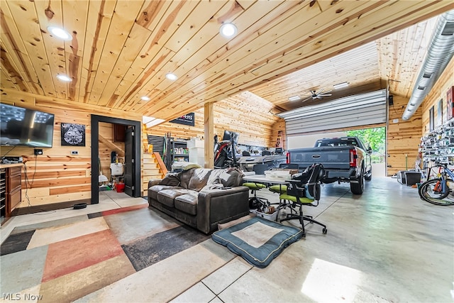 living room featuring wooden walls, ceiling fan, wood ceiling, and concrete flooring