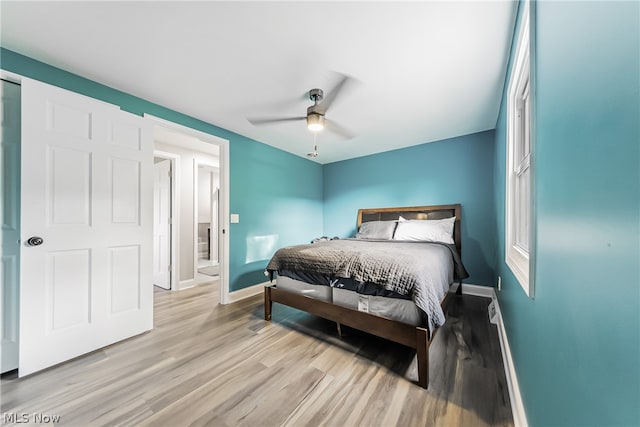 bedroom with light hardwood / wood-style floors and ceiling fan