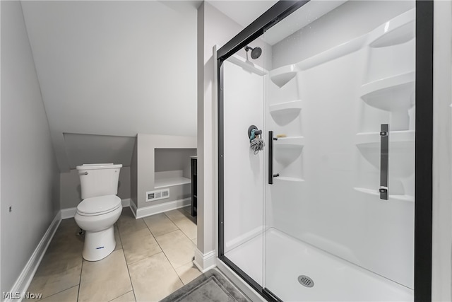 bathroom featuring a shower with shower door, tile flooring, and toilet