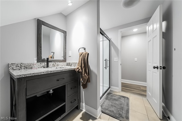 bathroom featuring tile floors, an enclosed shower, and large vanity