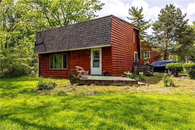 back of house with a lawn