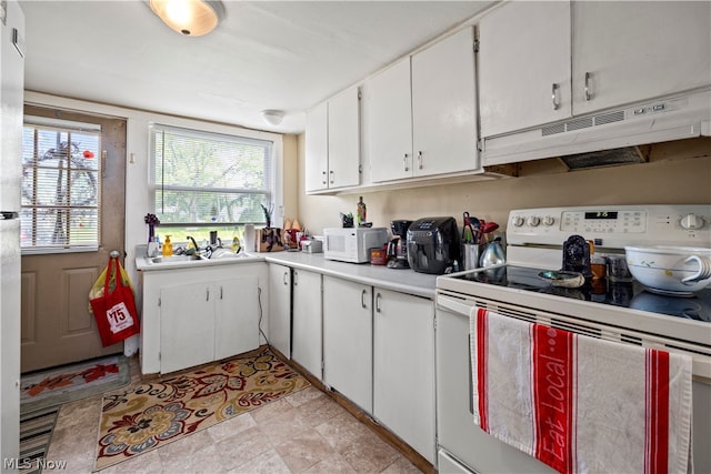 kitchen with sink, light tile flooring, white appliances, and white cabinetry