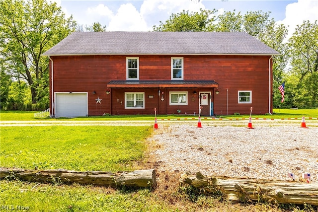 view of front of home with a garage and a front lawn