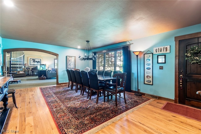 dining area featuring hardwood / wood-style floors and a textured ceiling