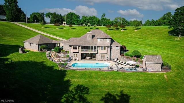 back of property featuring a lawn and a patio area