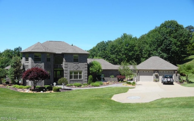 view of front of property featuring a garage and a front lawn