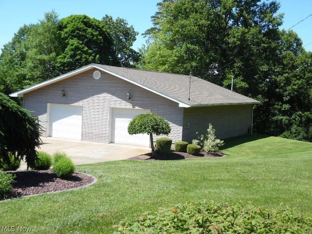 view of property exterior with a garage and a lawn