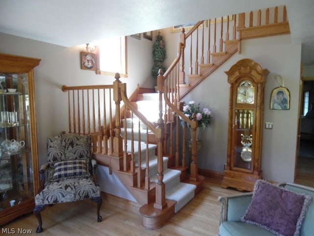 staircase with hardwood / wood-style flooring