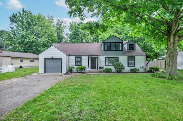 view of front of home featuring a front yard and a garage