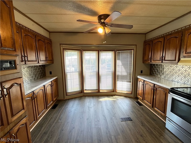 kitchen featuring electric stove, backsplash, and dark hardwood / wood-style flooring