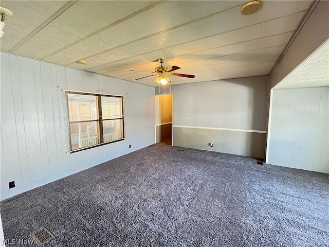 spare room featuring a textured ceiling, carpet, and ceiling fan