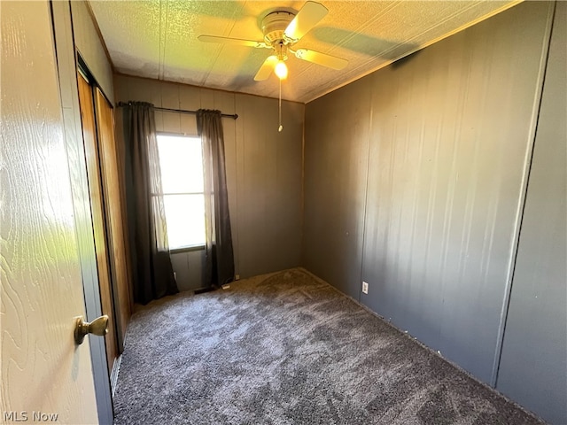 empty room featuring carpet floors and ceiling fan