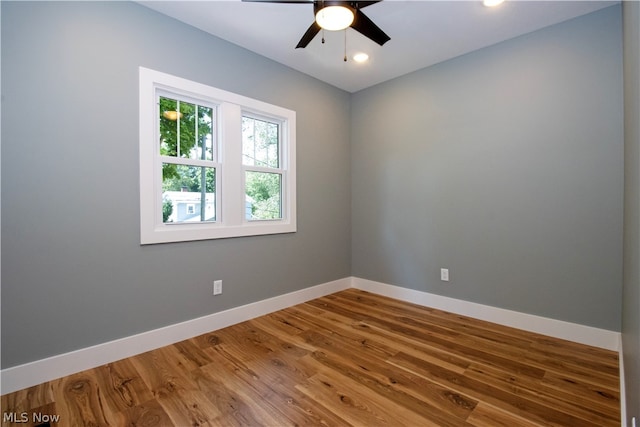 empty room featuring ceiling fan and hardwood / wood-style flooring