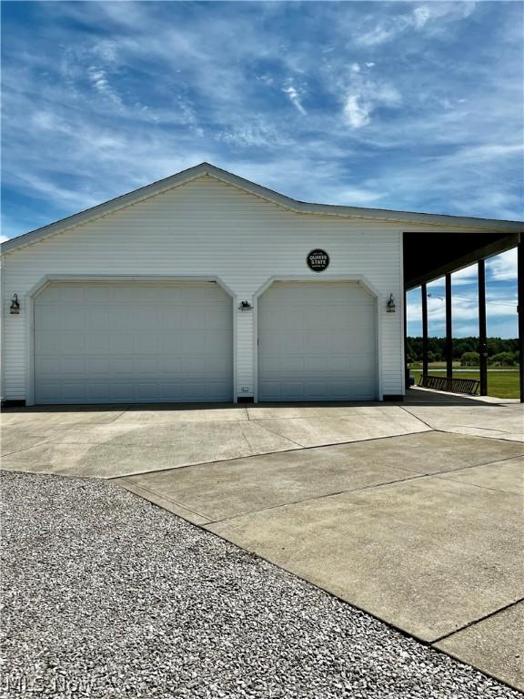 exterior space with a garage and an outdoor structure