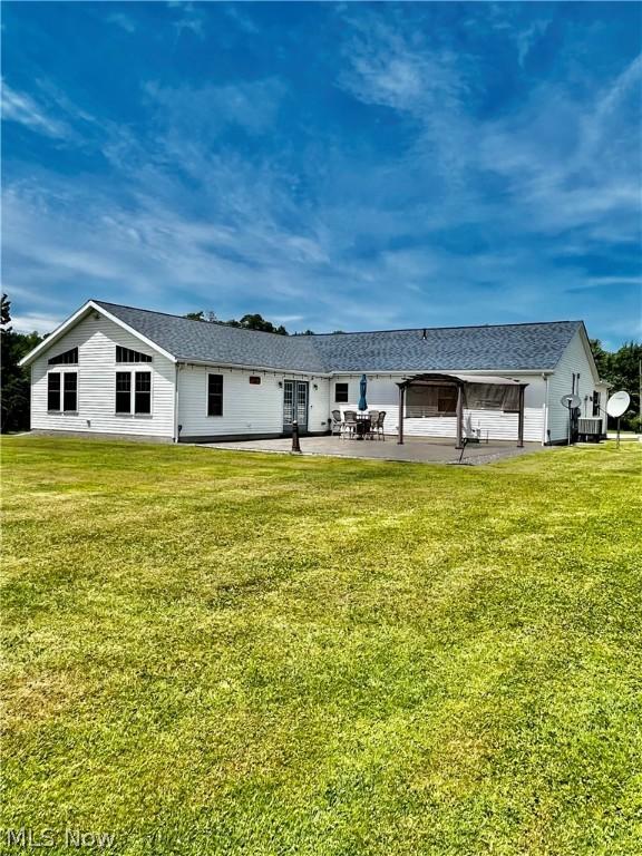 back of house featuring a yard and a patio area