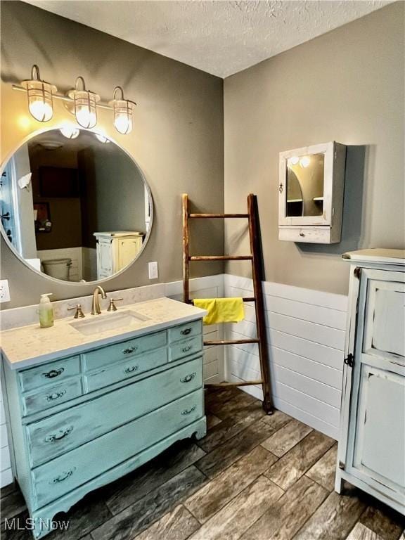 bathroom with vanity and a textured ceiling