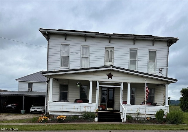 italianate home with a porch and a carport