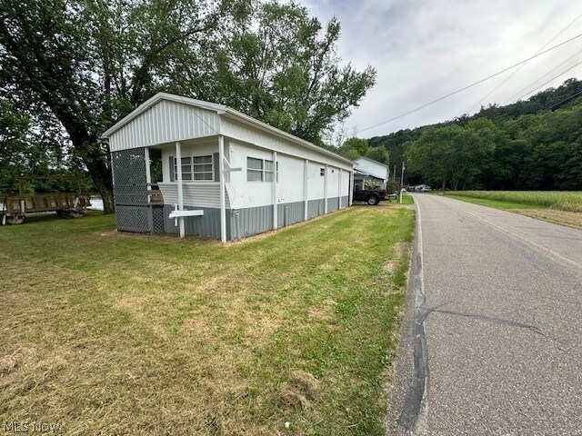 view of side of home featuring a yard