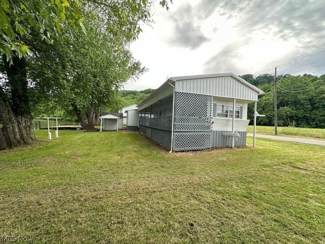 view of side of home with a lawn