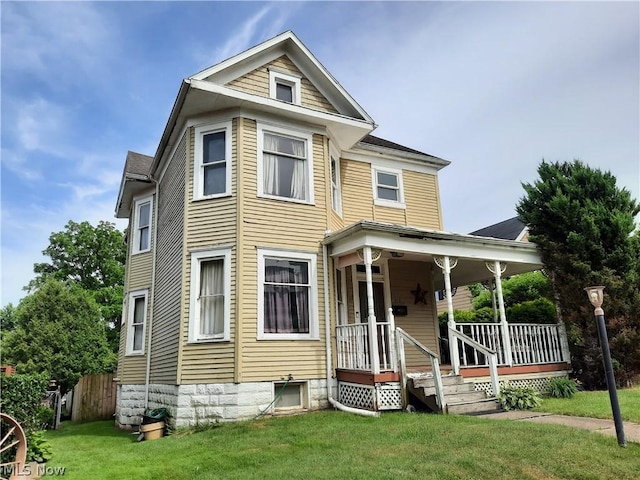 view of front of property with a front lawn and a porch