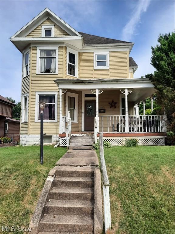 view of front facade with a front yard and a porch