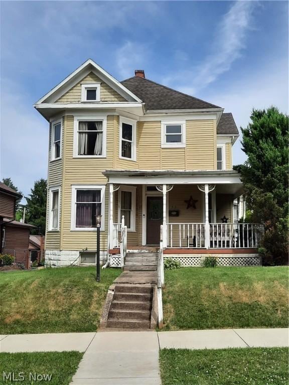 view of front of house featuring a front yard and a porch