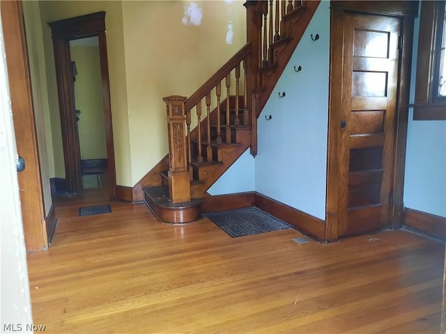 stairway with hardwood / wood-style floors