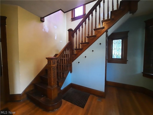 staircase featuring hardwood / wood-style floors and plenty of natural light