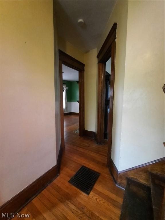 hall with dark hardwood / wood-style flooring