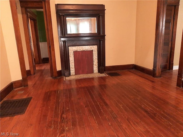 unfurnished living room with dark wood-type flooring